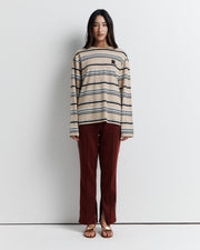 The Varsity Long Sleeve Top is a relaxed-fit striped crew neck tee, featuring long sleeves and the signature Romy Athletic Society 'R' embroidery for a sporty, elevated look.