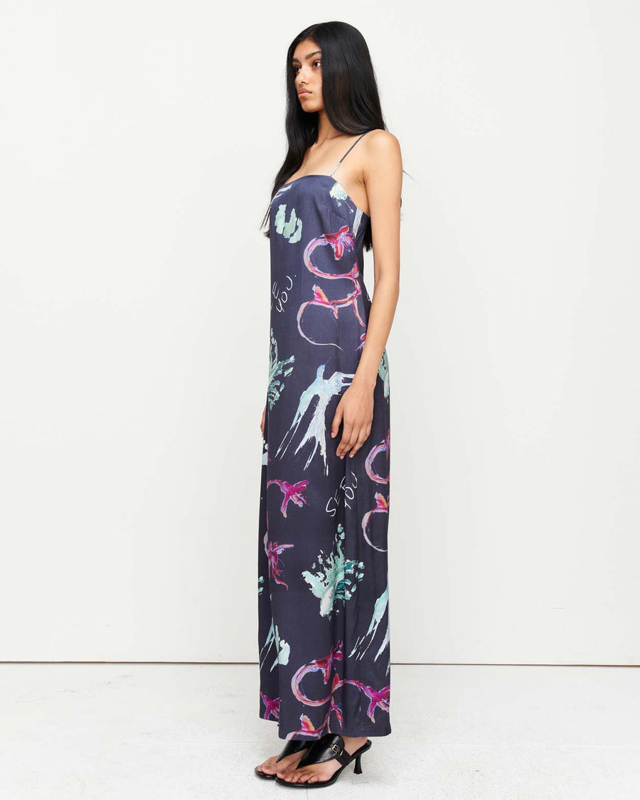 Elegant and timeless, the Joy Slip Dress features a column silhouette with a straight neckline, rouleau straps, and an invisible back zip. Adorned with exclusive artwork by Anouk Colantoni.