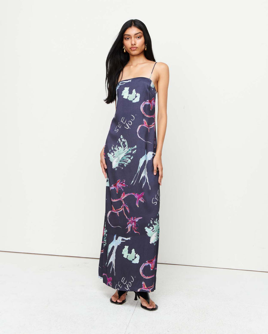 Elegant and timeless, the Joy Slip Dress features a column silhouette with a straight neckline, rouleau straps, and an invisible back zip. Adorned with exclusive artwork by Anouk Colantoni.