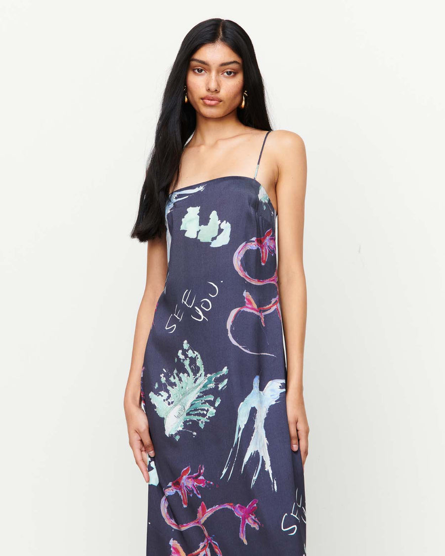 Elegant and timeless, the Joy Slip Dress features a column silhouette with a straight neckline, rouleau straps, and an invisible back zip. Adorned with exclusive artwork by Anouk Colantoni.