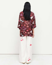 Effortlessly chic, the June Shirt features an oversized fit with short sleeves, a concealed placket, and exaggerated sleeves. Adorned with exclusive artwork in collaboration with Anouk Colantoni.