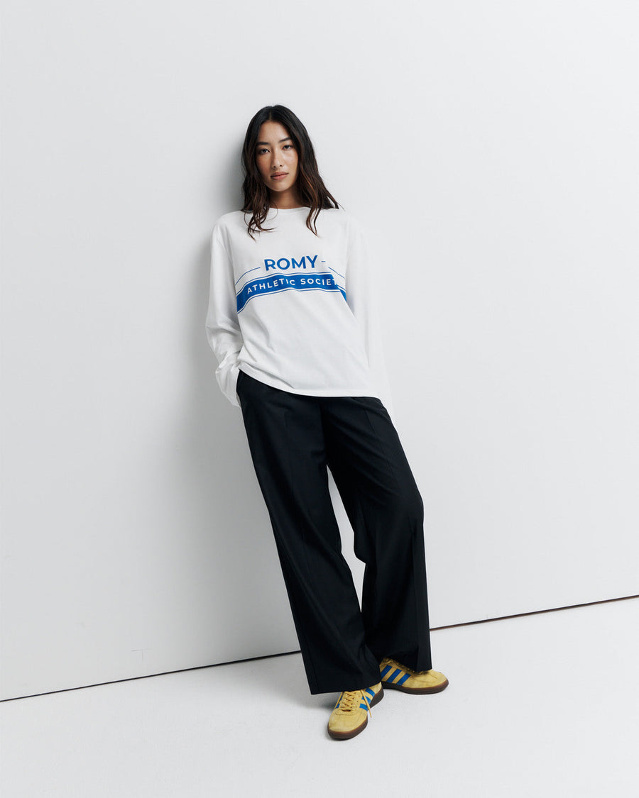 The RAS Long Sleeve Tee is a classic crew neck boyfriend tee with long sleeves, featuring the signature Romy Athletic Society logo for an effortlessly cool, sporty look.