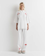 Effortlessly chic, the Cherry Shirt features an oversized fit with short sleeves, a concealed placket, and exaggerated sleeves. Adorned with exclusive artwork in collaboration with Anouk Colantoni.