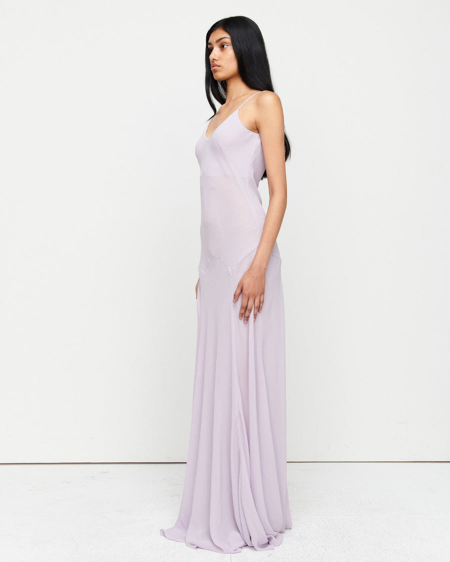 The Charlie Gown in Lilac is a reimagined Romy favorite, featuring a floor-length silhouette, adjustable straps, and a separate slip. Crafted from 100% polyester for effortless elegance and versatility.