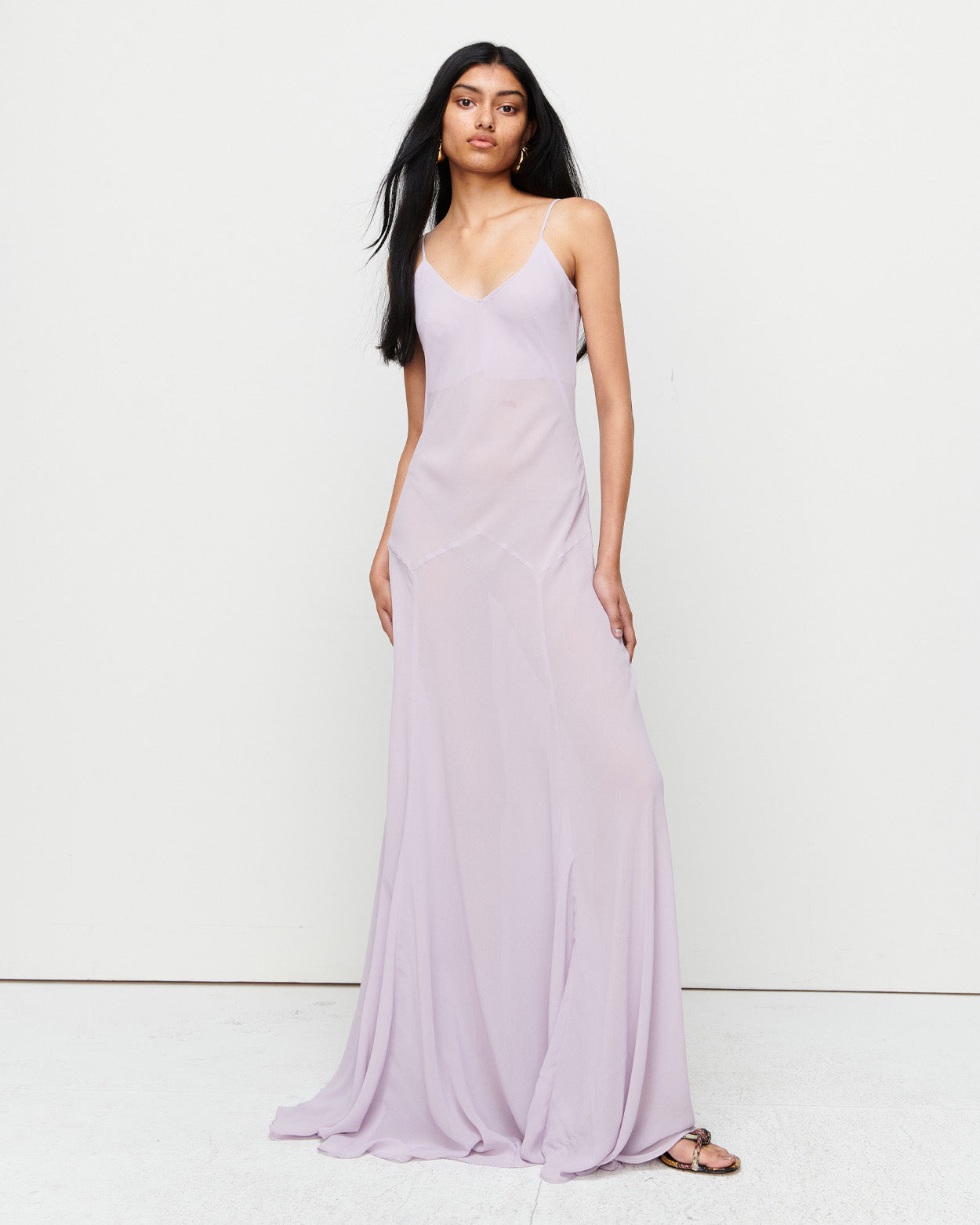 The Charlie Gown in Lilac is a reimagined Romy favorite, featuring a floor-length silhouette, adjustable straps, and a separate slip. Crafted from 100% polyester for effortless elegance and versatility.