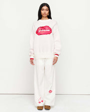 Stay cozy in the Lips Sweater – a classic crew neck, relaxed boyfriend fit, featuring exclusive artwork in collaboration with Anouk Colantoni for a bold, artistic touch.