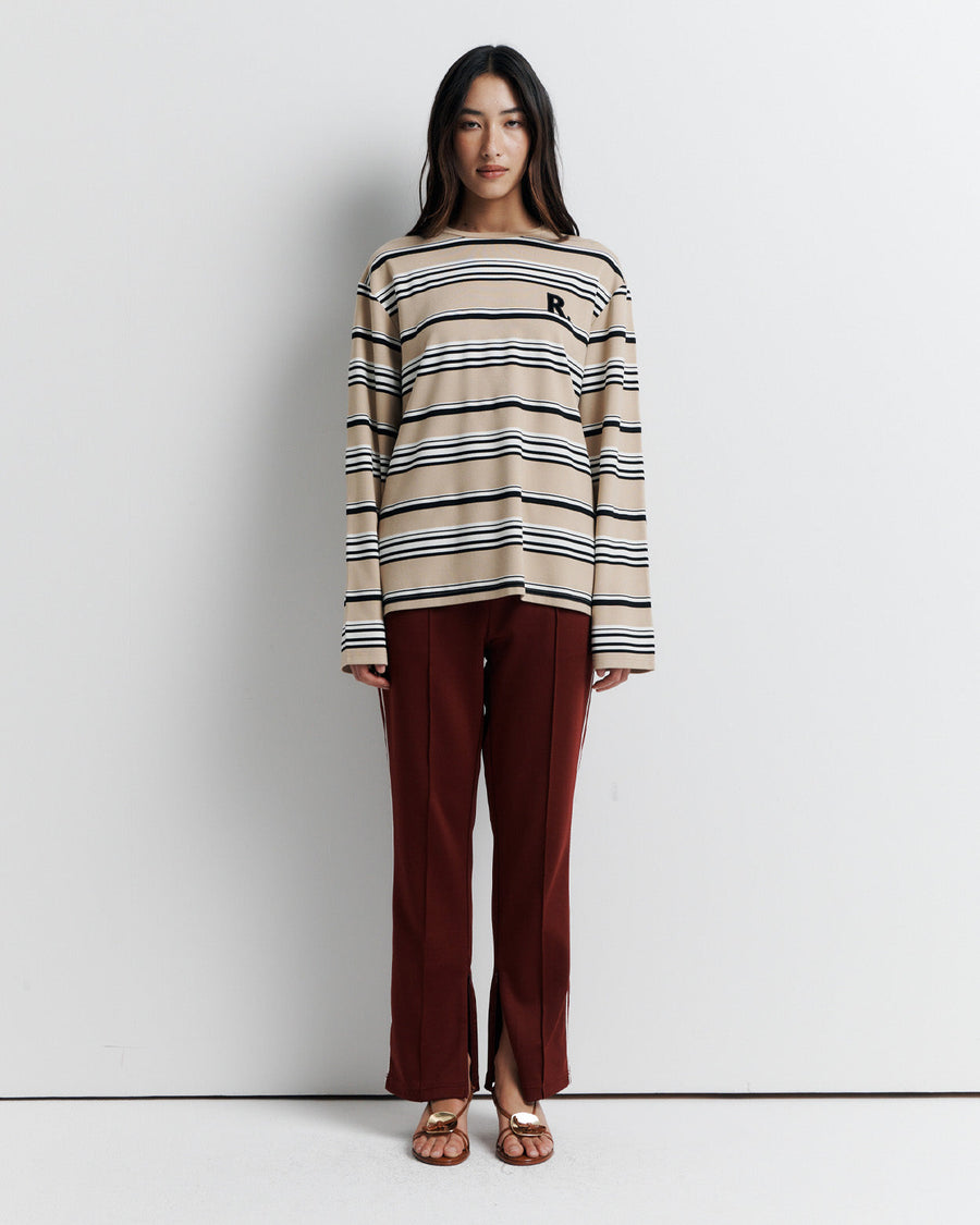The Varsity Long Sleeve Top is a relaxed-fit striped crew neck tee, featuring long sleeves and the signature Romy Athletic Society 'R' embroidery for a sporty, elevated look.
