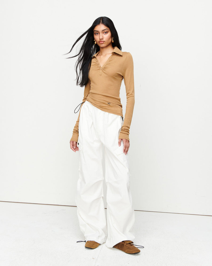 Elevate your wardrobe with the Louise Knit Top in Tan—a collared Henley-style design featuring soft gathers over the bust and elongated sleeves for effortless layering. Crafted from a luxe blend of Lyocell, acrylic, and wool, and finished with our signature ‘R’ embroidery.