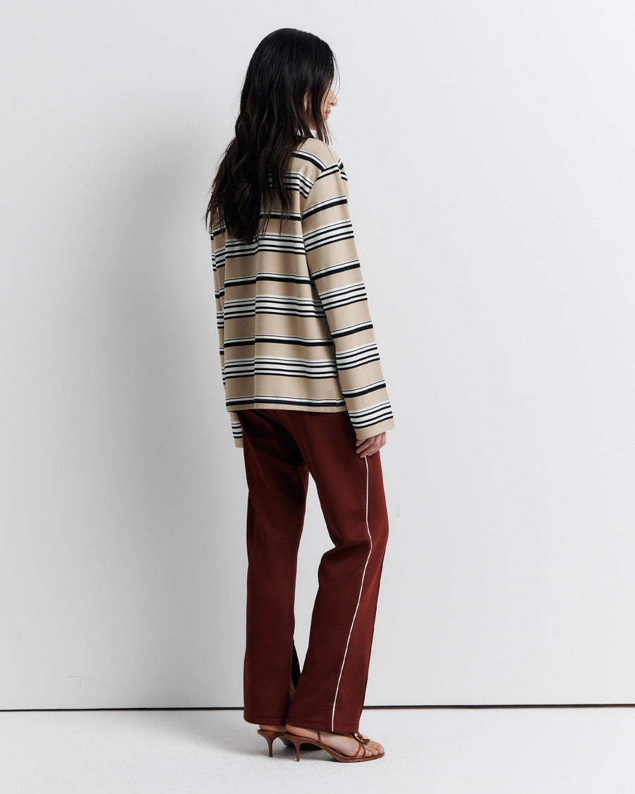 The Varsity Long Sleeve Top is a relaxed-fit striped crew neck tee, featuring long sleeves and the signature Romy Athletic Society 'R' embroidery for a sporty, elevated look.