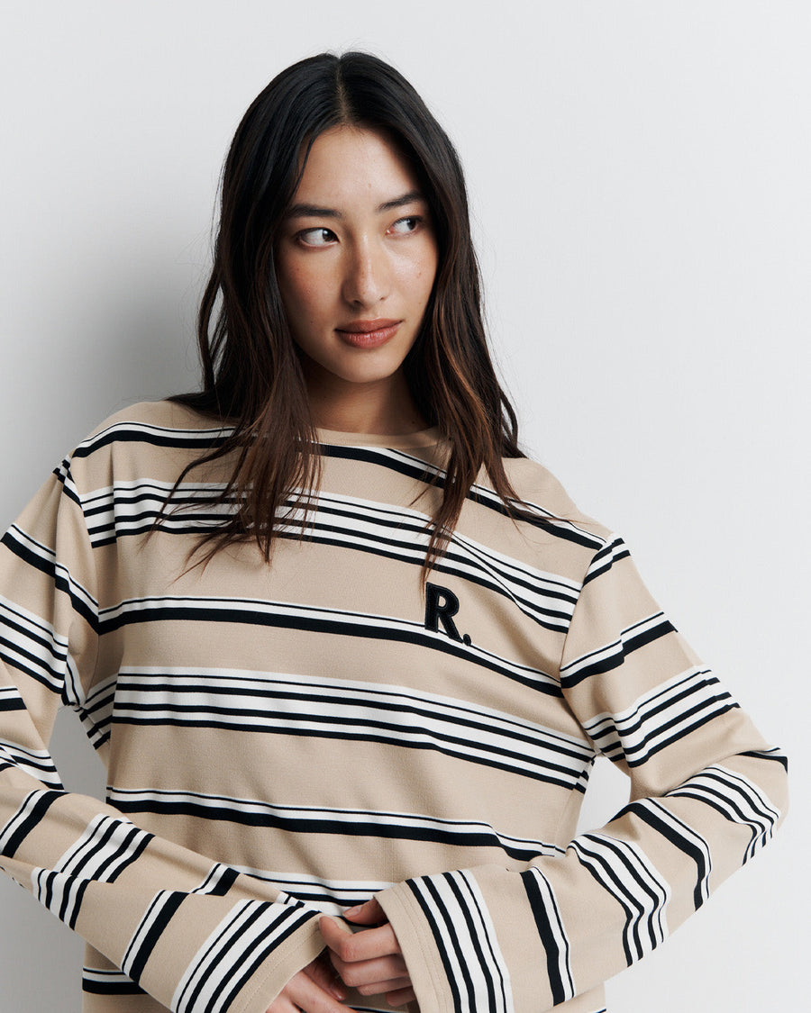 The Varsity Long Sleeve Top is a relaxed-fit striped crew neck tee, featuring long sleeves and the signature Romy Athletic Society 'R' embroidery for a sporty, elevated look.