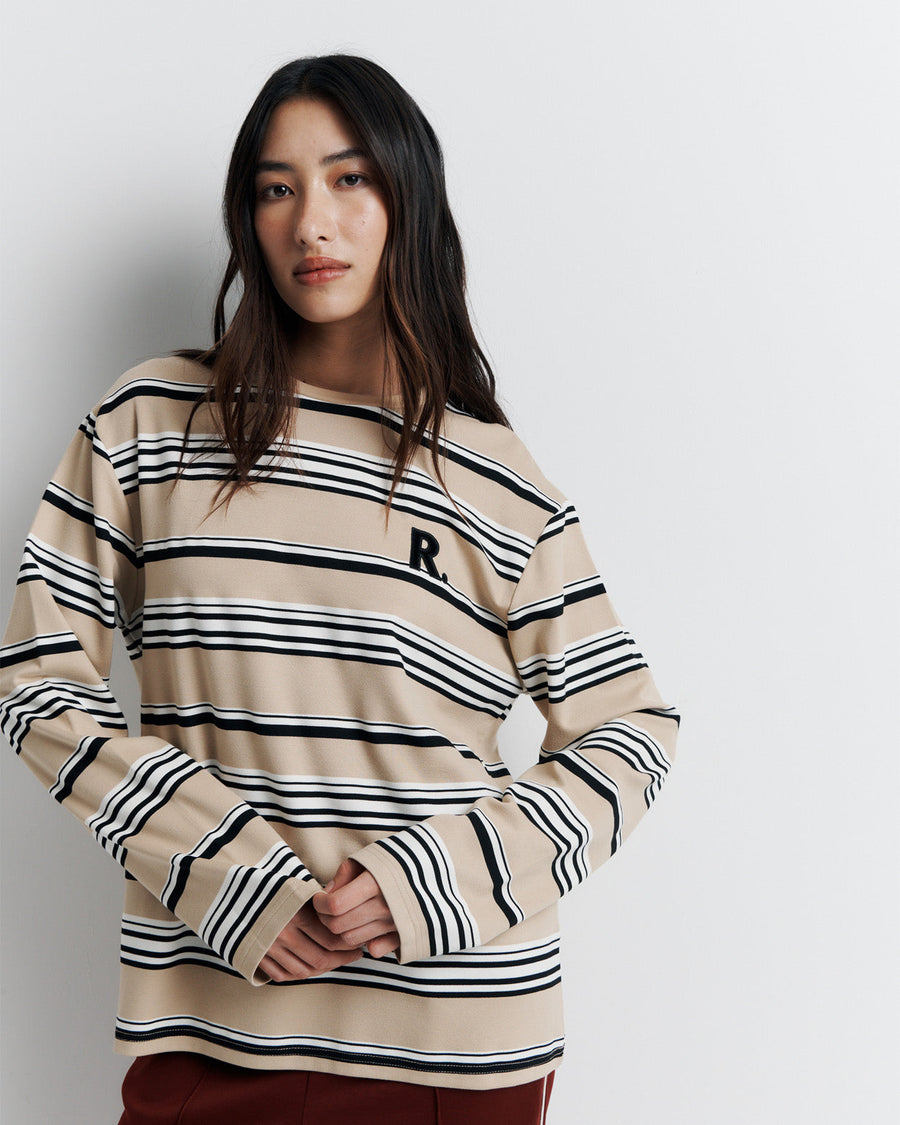 The Varsity Long Sleeve Top is a relaxed-fit striped crew neck tee, featuring long sleeves and the signature Romy Athletic Society 'R' embroidery for a sporty, elevated look.
