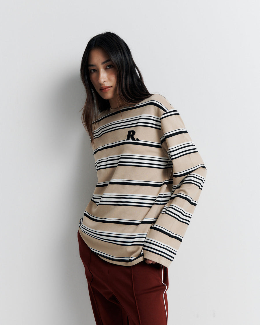 The Varsity Long Sleeve Top is a relaxed-fit striped crew neck tee, featuring long sleeves and the signature Romy Athletic Society 'R' embroidery for a sporty, elevated look.