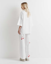 Effortlessly chic, the Cherry Shirt features an oversized fit with short sleeves, a concealed placket, and exaggerated sleeves. Adorned with exclusive artwork in collaboration with Anouk Colantoni.