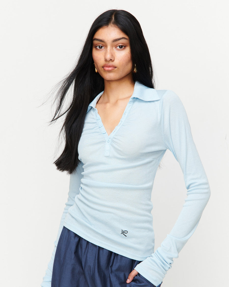 Elevate your wardrobe with the Louise Knit Top in Blue—a collared Henley-style design featuring soft gathers over the bust and elongated sleeves for effortless layering. Crafted from a luxe blend of Lyocell, acrylic, and wool, and finished with our signature ‘R’ embroidery.