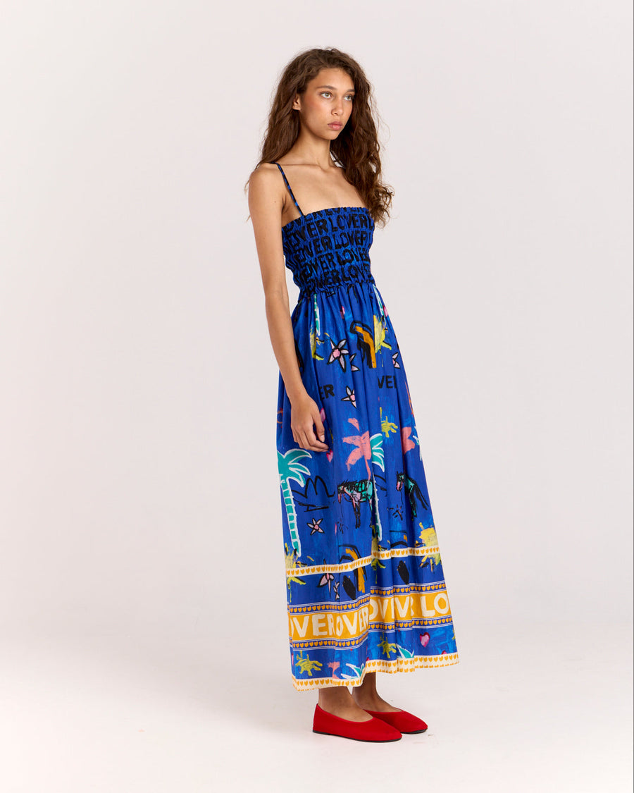 Embrace effortless summer style with the Lover Sundress, featuring Jake Pedro's exclusive Lover Print. Crafted from a breezy blend of cotton and silk, it includes adjustable straps, a flattering shirred bodice, and side pockets for added convenience.