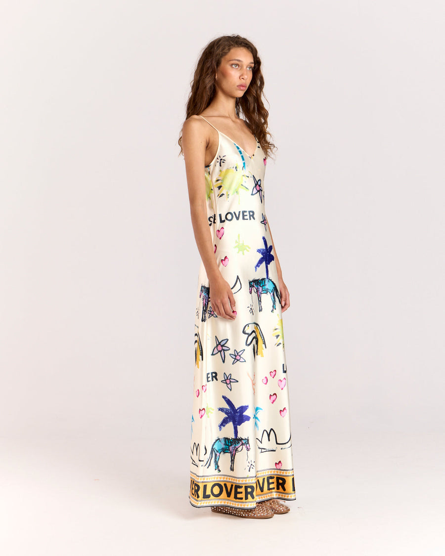 Elevate your style with the Lover Slip Dress, showcasing Jake Pedro's exclusive Lover Print. Crafted from luxurious satin with a high sheen, it features a flattering V-neckline, adjustable straps, and a graceful floor-length hem.